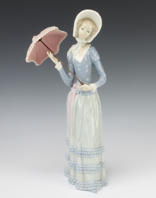 A Lladro figure of a lady holding a parasol 31cm 