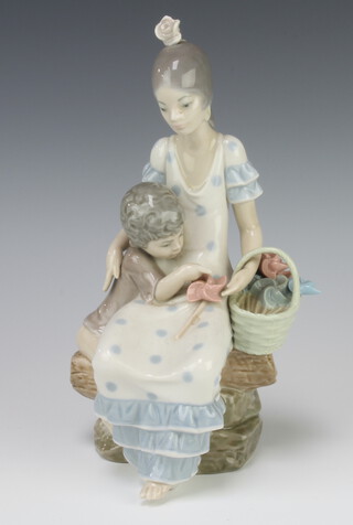 A Lladro group of a lady with child and a basket of pin wheels 22cm 