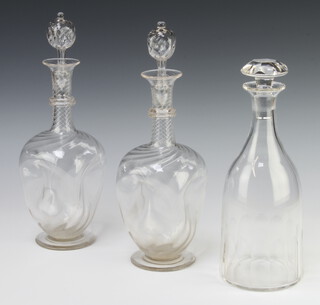 A pair of Edwardian waisted decanters and stoppers 30cm, a mallet shaped decanter and stopper 27cm 
