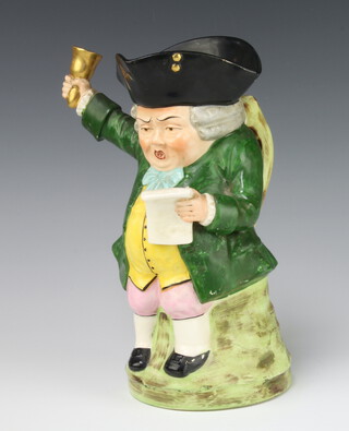 A Staffordshire Toby jug in the form of a town crier 24cm x 11cm 