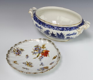 A Victorian Worcester blue and white twin handled Willow pattern tureen, the base with green Worcester mark 13cm h x 34cm w x 17cm d (chips to the base) together with a Continental scalloped shaped dish with floral decoration 25cm 
