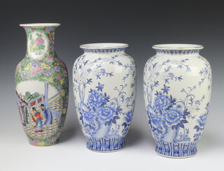 A pair of modern Chinese blue and white oviform vases decorated with flowers 31cm together with a modern famille rose oviform vase decorated with panels of figures 37cm 