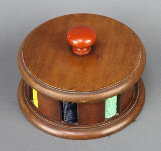 A cylindrical Art Deco mahogany game counter bank comprising 191 circular coloured plastic counters 8cm h x 17cm 