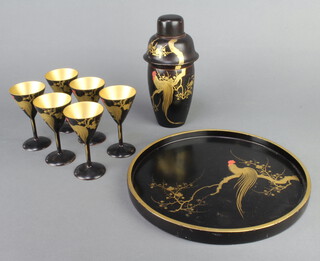 An Art Deco Chinese black lacquered 9 piece cocktail set comprising circular tray 27cm diam., cocktail shaker 27cm h, 6 glasses 11cm (1 with damaged foot) 