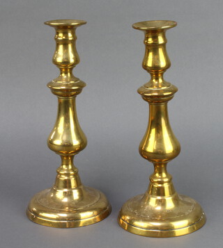 A pair of 19th Century polished brass candlesticks, 1 with ejector, 27cm h x 12cm