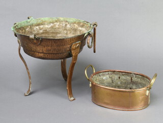 An oval copper and brass twin handled planter 8cm x 21cm w x 15cm together with an Eastern circular planished copper bowl on shaped supports 26cm x 28cm  