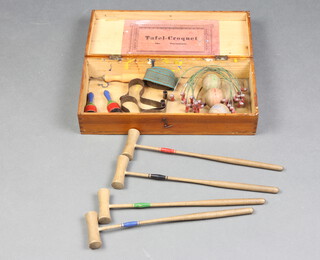 A 19th Century French tabletop croquet set comprising 3 balls, 4 mallets and 9 hoops, contained in a rectangular pine box 
