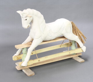 A white painted carved hardwood rocking horse 85cm h x 111cm w x 46cm d 