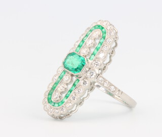 A platinum Edwardian style emerald and diamond up-finger ring, the emeralds approx. 0.78ct, diamonds 0.5ct, 5.3 grams, size L 