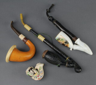 A Meerschaum pipe, a wooden pipe, a wooden and porcelain pipe, a pipe bowl 