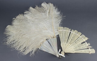 A mother of pearl and ostrich feather fan (7 sticks damaged) together with a pierced ivory fan (damaged) 
