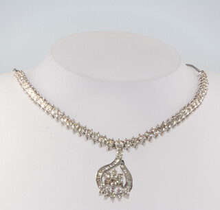 An 18ct white gold brilliant and baguette cut diamond necklace, approx. 9.07ct, 25.7 grams, 44cm 