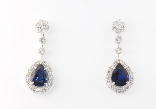 A pair of 18ct white gold pear shaped sapphire and diamond drop earrings, the sapphires 3.84ct, the brilliant cut diamonds 1.06ct, 5.8 grams, 29mm 