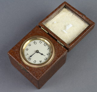 A 1930's travelling timepiece with silvered dial and Arabic numerals contained in a leather finished box 7cm x 8cm x 8cm 