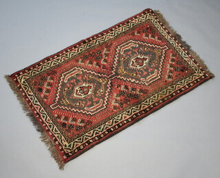 A red and black ground Afghan rug with central medallion  128cm x 81cm 