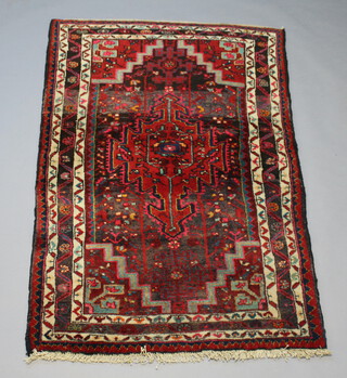 A North West Persian red and white ground rug with central medallion within multi row border 160cm x 102cm 