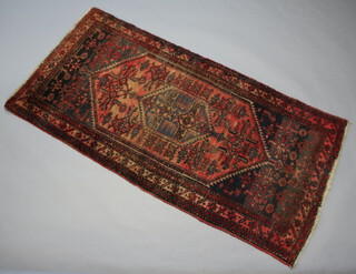 A red and blue Afghan rug with central medallion 201cm x 102cm 