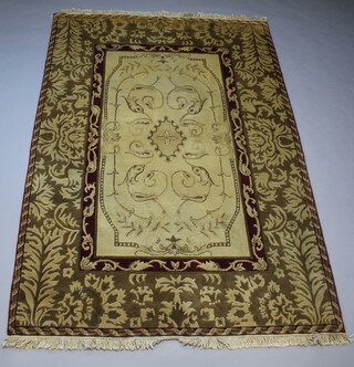 An Aubusson style brown and cream rug with central floral medallion within a 3 row border 272cm x 188cm 