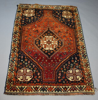 A brown and black ground rug with central medallion 184cm x 126cm 