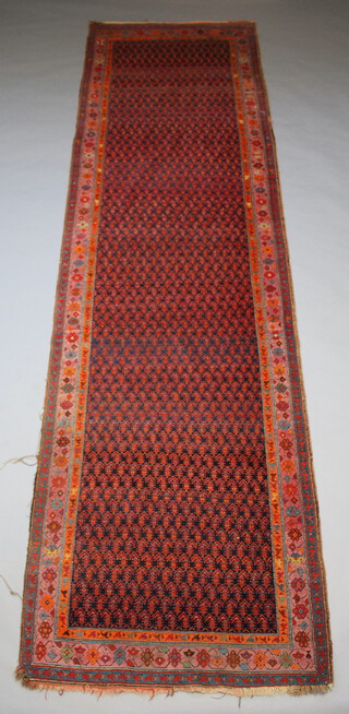 A blue, red, pink and orange ground runner with all over hook design within a 3 row border 405cm x 111cm  
