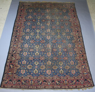 A blue, pink and green ground Persian carpet with all over floral design 387cm x 263cm 
