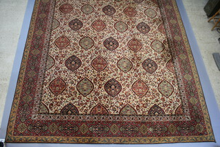 A Persian style machine made carpet with numerous ovals within a floral pattern 642cm x 324cm  