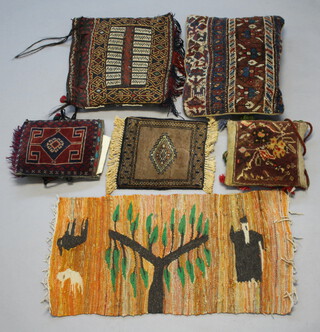 Four Persian carpet cushions 48cm x 38cm, 38cm x 42cm, 31cm x 25cm and 29cm x 27cm 