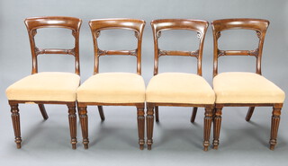 A set of 4 Victorian mahogany spoon back dining chairs with carved mid rail and over stuffed seats, raised on turned and reeded supports 86cm h x 49cm w x 45cm d (seat 28cm x 31cm) 