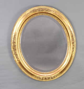 A Georgian style oval bevelled plate wall mirror contained in a decorative gilt frame with rose decoration 69cm x 60cm 
