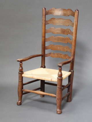 A 18th Century elm Lancashire ladder back chair with woven rush seat 