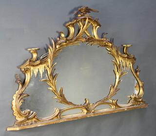 A 19th Century Chippendale style plate over mantel mirror contained in a carved gilt wood frame surmounted by a bird 89cm x 130cm 