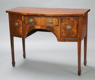 A Georgian style mahogany bow front sideboard fitted a drawer flanked by cupboard and further drawer, raised on square tapered supports, spade feet 91cm h x 121cm w x 54cm d  