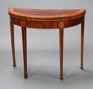 A Georgian inlaid and crossbanded mahogany demi-lune tea table, raised on square tapered supports, spade feet 73cm h x 91cm w x 44cm d 