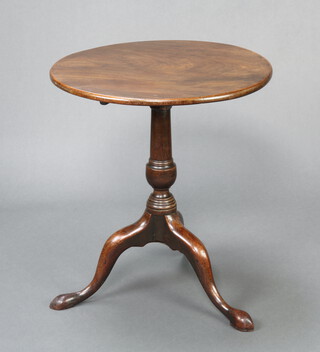 A circular Georgian mahogany snap top wine table raised on a pillar and tripod base 65cm h x 57cm diam.  