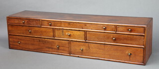 A Georgian crossbanded mahogany rectangular table top chest of 8 drawers with brass handles 21cm h x 87cm w x 21cm d 
