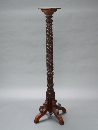 A William IV carved and turned mahogany bedpost torchere, raised on a tripod base 155cm h x 29cm diam. 