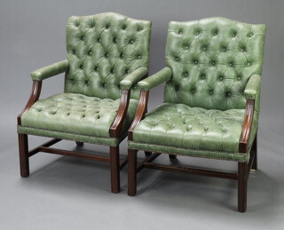 A handsome pair of Gainsborough style open arm library chairs upholstered in faded green buttoned leather, raised on square supports 99cm h x 70cm w x 60cm d (seat 51cm x 37cm)