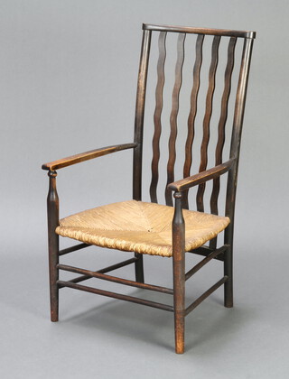 An Edwardian Voisey style beech framed open arm chair with woven rush seat 84cm h x 47cm w x 39cm (seat 33cm x 30cm) 
