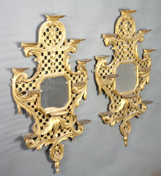 A pair of 19th Century Chippendale style octagonal plate mirrors contained in pierced gilt carved wood frames with 10 scallop shaped shells 101cm x 54cm 