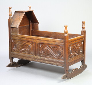 A 17th/18th Century style carved oak rocking crib formed of old timber 84cm h x 61cm w x 95cm l 