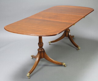 A Georgian style crossbanded mahogany twin pillar dining table with 1 extra leaf 73cm h x 91cm w x 150cm l x 194cm l when extended 