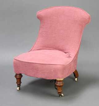A Victorian nursing chair with pink loose cover, on turned supports 73cm h x 53cm w x 49cm d (seat 42cm w x 37cm d)