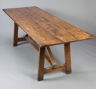 An early 20th Century 17th Century style elm trestle table, the top formed of 3 planks with H framed stretcher 76cm h x 79cm w x 200cm l