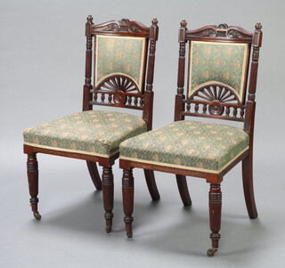 A pair of Victorian mahogany dining chairs, the seats and backs upholstered in green floral material 96cm h x 48cm w x 46cm d (seat 35cm x 40cm) 