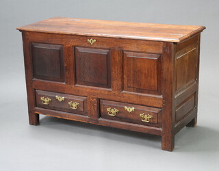 An 18th Century oak mule chest of panelled construction, the base fitted 2 long drawers 76cm h x 129cm w x 50cm d 