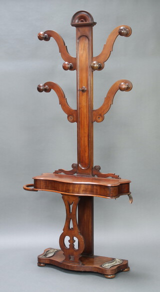 A Victorian mahogany hat and coat hall stand, the base fitted a glove box of serpentine outline, complete with drip trays, 217cm h x 99cm w x 33cm d 