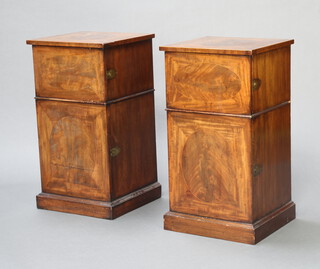 A pair of 19th Century inlaid mahogany and cross banded pedestal cabinets fitted double cupboards enclosed by panelled doors, raised on a platform base 76cm h x 41cm w x 40cm d 