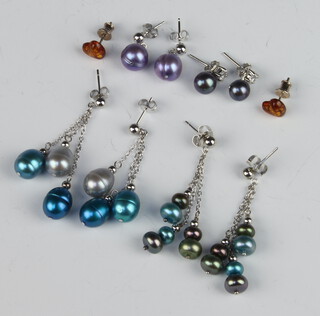 Four pairs of silver cultured pearl earrings together with a pair of amberoid ditto 