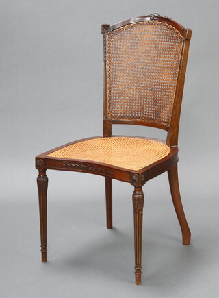 An Edwardian Georgian style carved mahogany bedroom chair with woven cane seat and back, raised on turned and fluted supports 92cm h x 46cm w x 44cm d (seat 30cm x 28cm) 