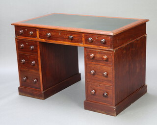 A Victorian mahogany kneehole pedestal desk with inset writing surface above 1 long and 8 short drawers with tore handles 76cm h x 117cm w x 70cm d 